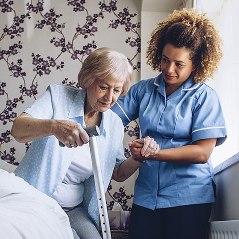 Caregiver helping an older woman at home